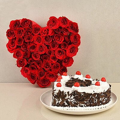 Heart Shaped Arrangement of 50 Red Roses - 1 Kg Heart Shape Black Forest Cake - Spotlight